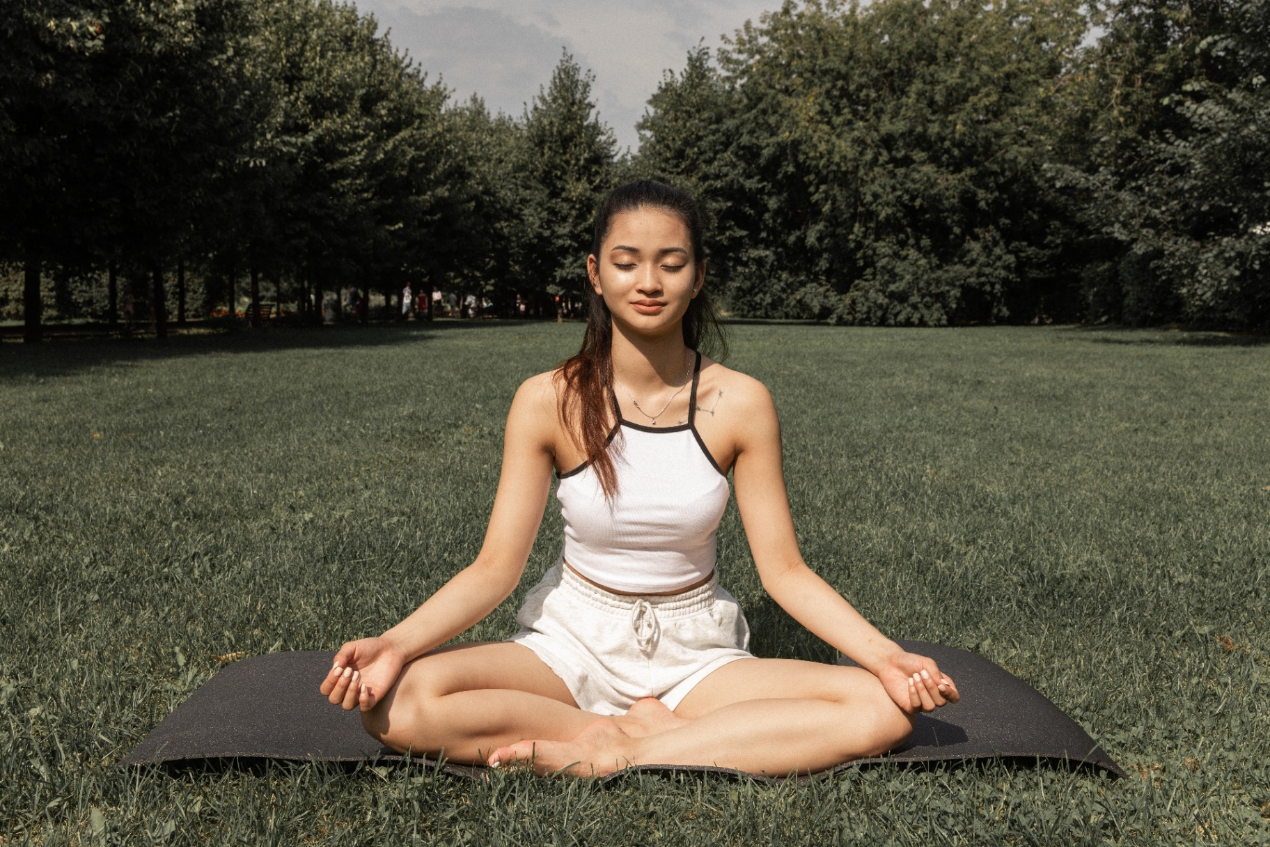 Woman meditating in the park